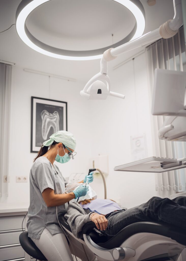A dentist performing a dental procedure on a patient in a modern clinic, showcasing advanced dental equipment.