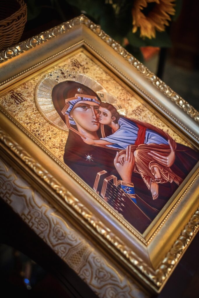 A beautifully framed religious icon depicting the Virgin Mary and Jesus, showcasing intricate details and vibrant colors.