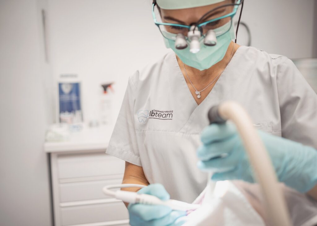Dental professional performing a procedure with precision tools in a modern clinic environment.
